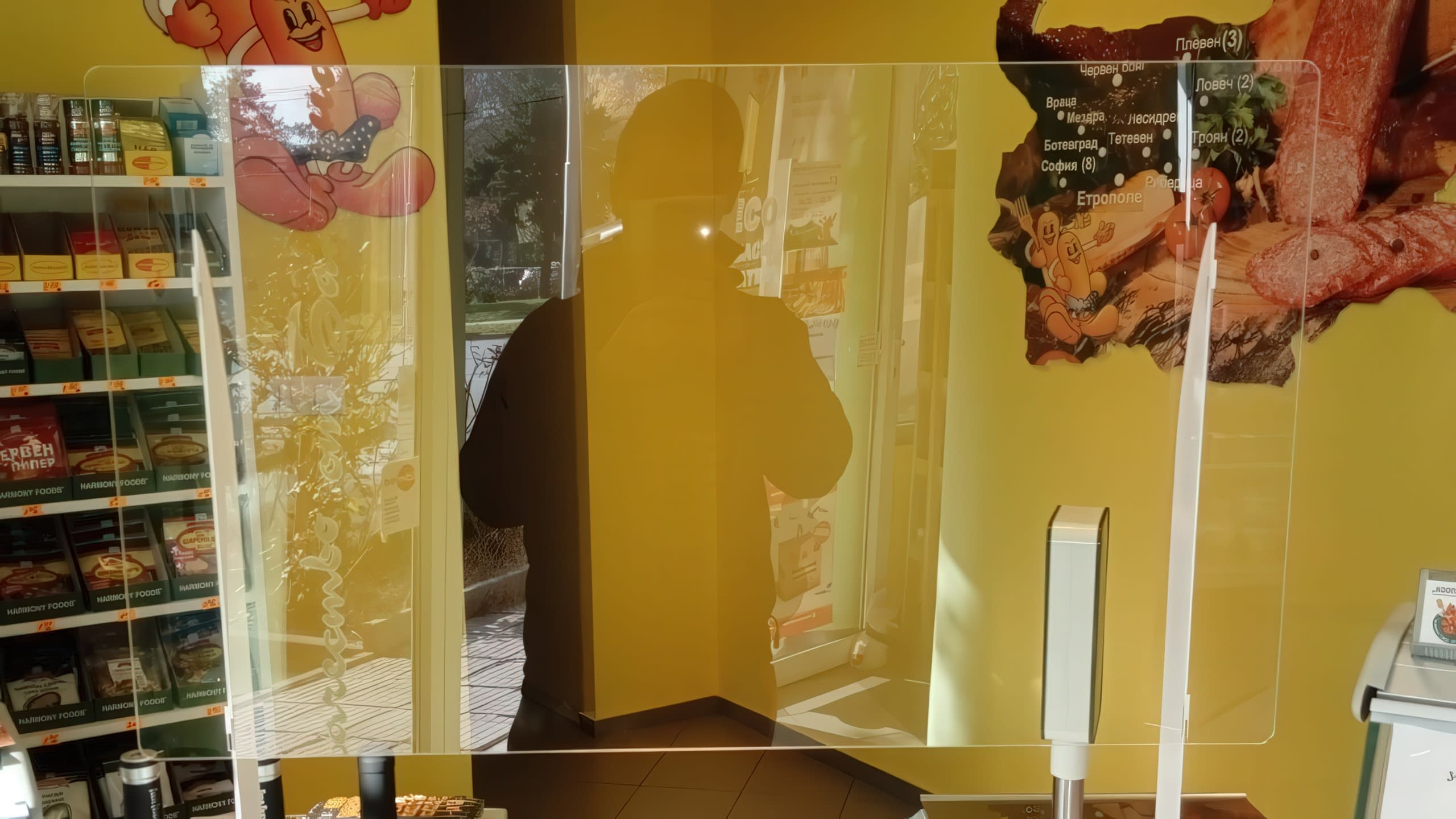 Прозрачна плексигласова преграда на щанд за месо и колбаси в супермаркет.